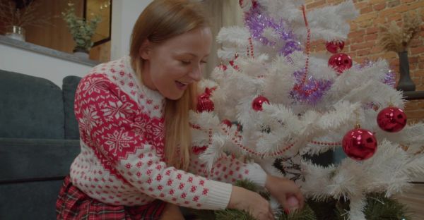 MILF in miniskirt rocks Santa hat while pleasuring herself with a festive dildo on the couch - alphaporno.com on poweredporn.com